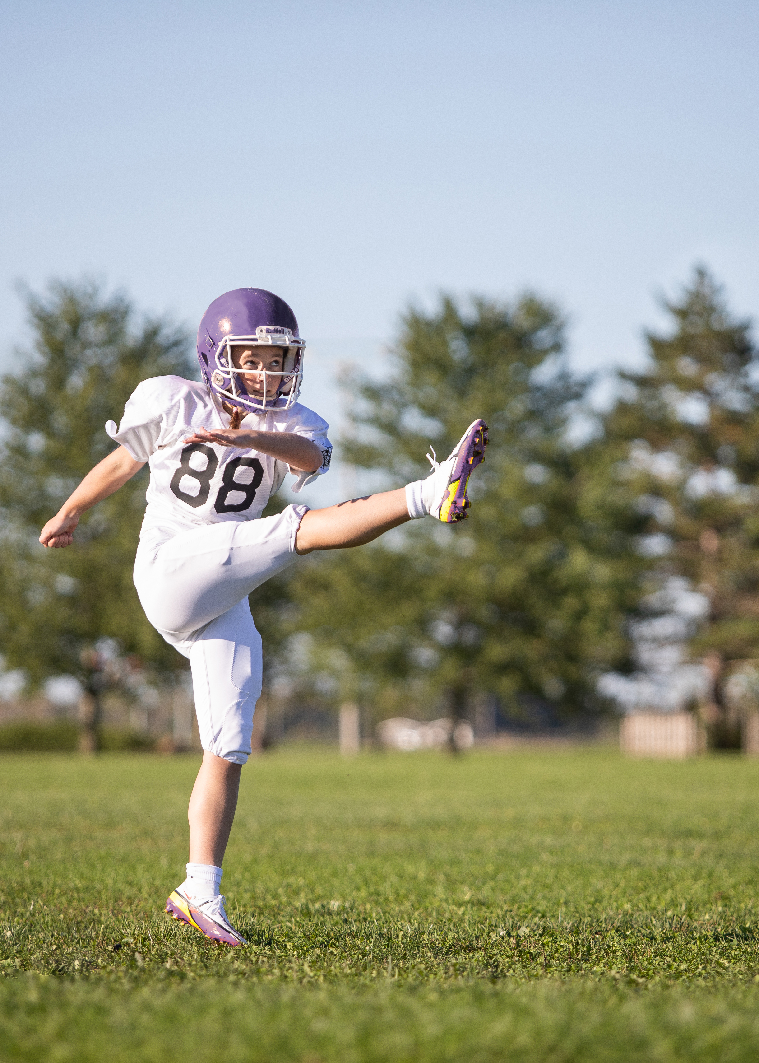 Mia kicking a football