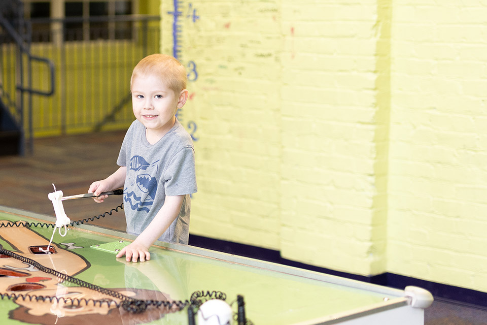 Cal playing at a large game table after his clinical trial.