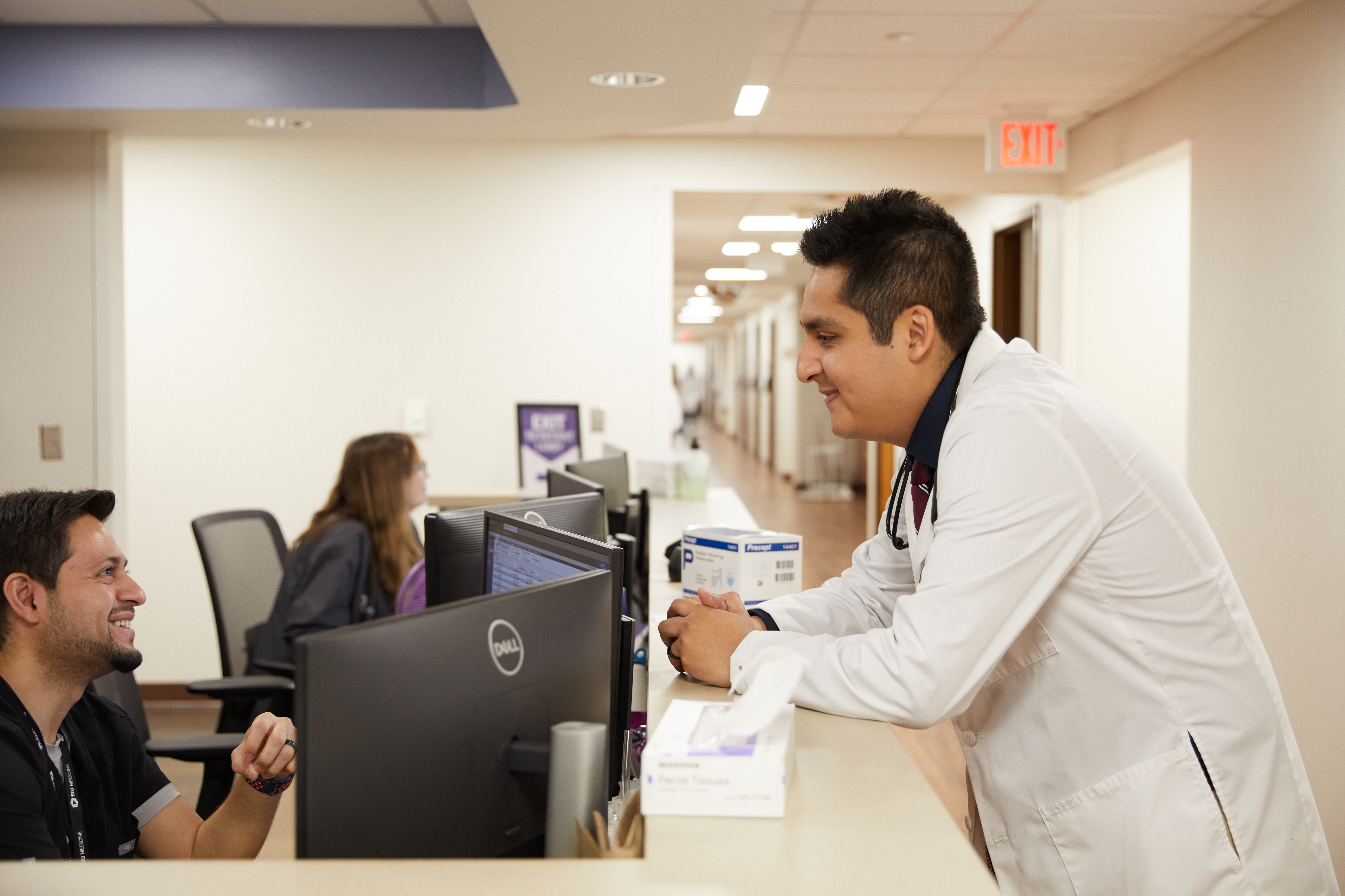 Dr. Julio Mendoza Estrada talks to a coworker