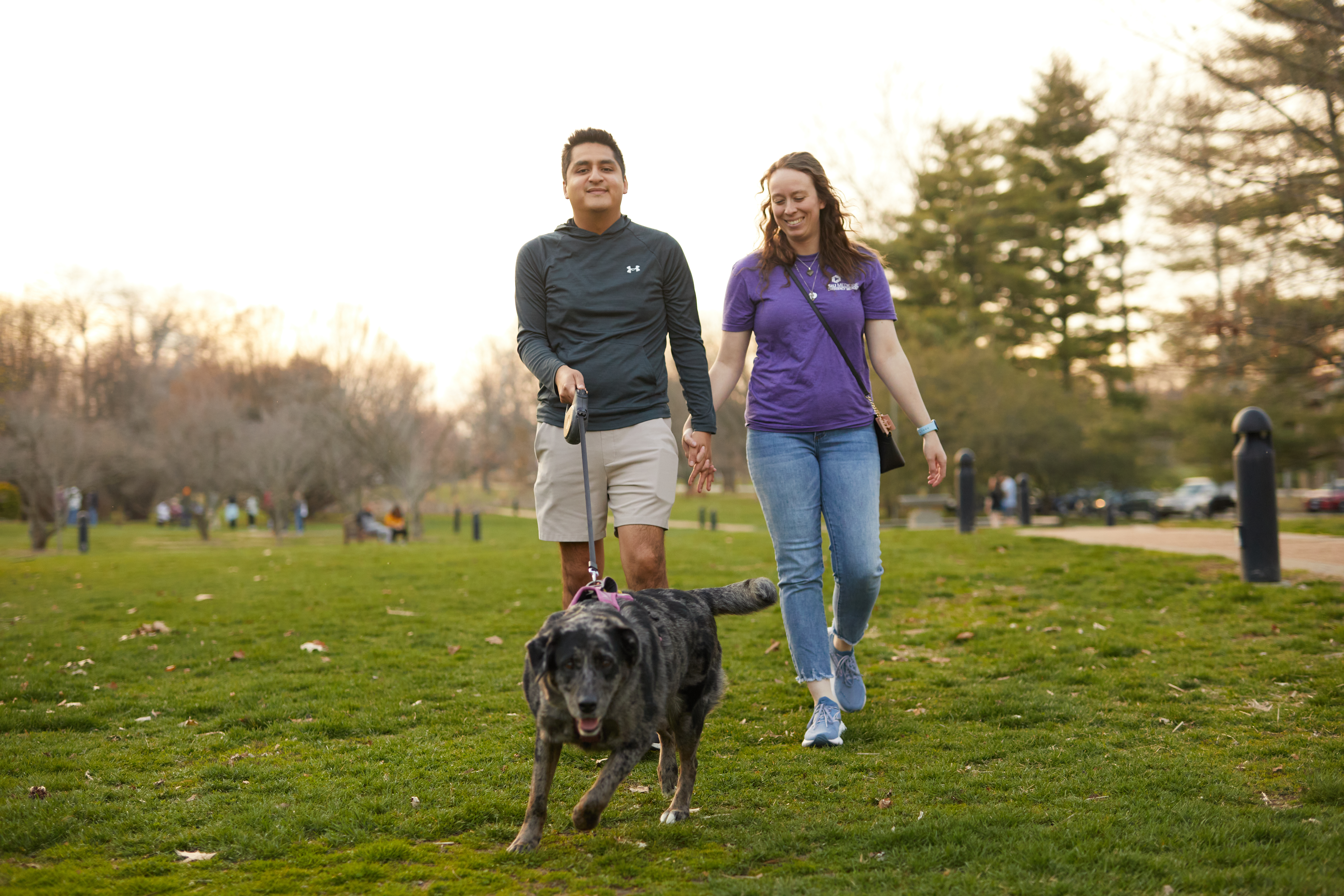 Julio Mendoza Estrada and Meghan Mendoza walk their dog