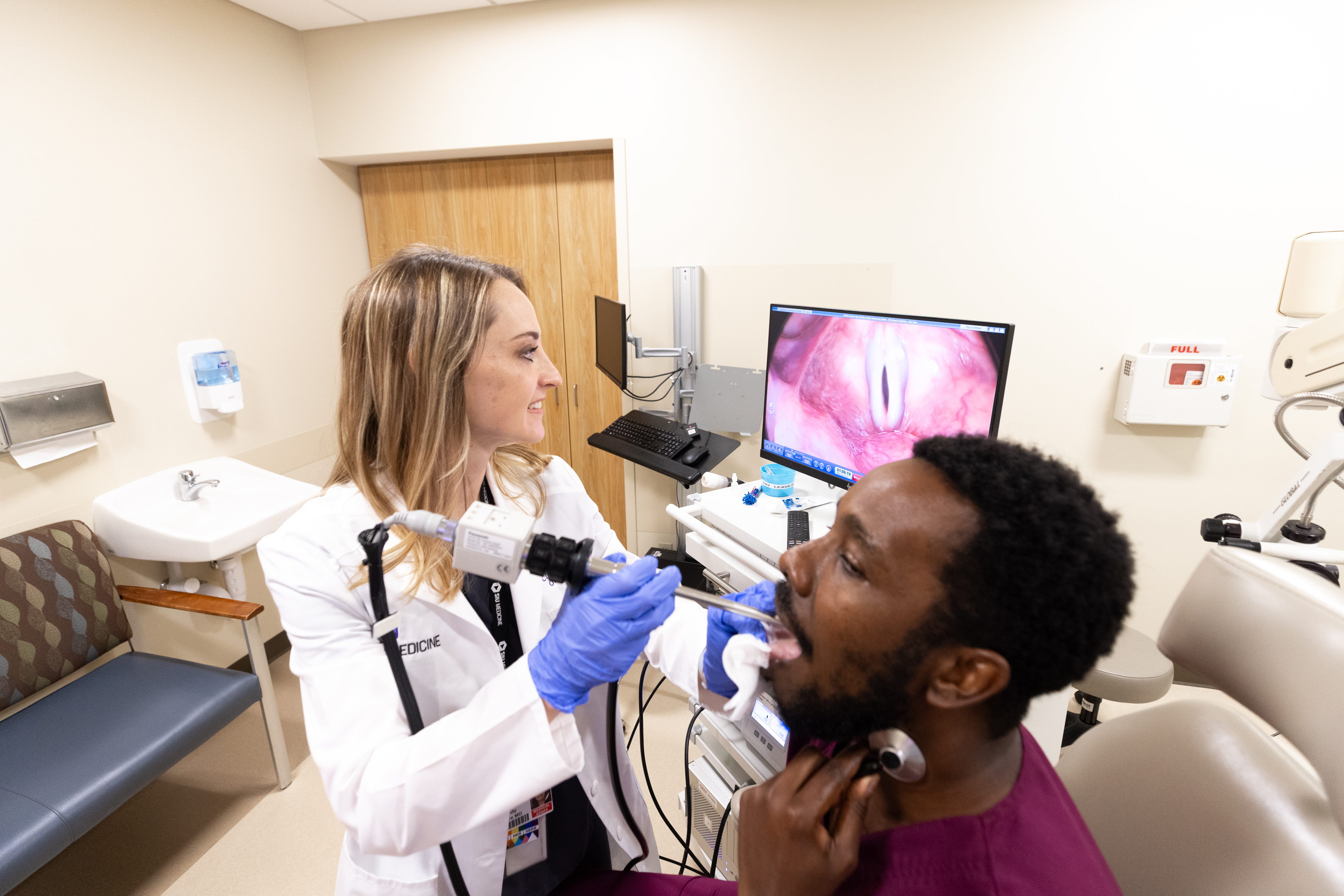 Laryngologist Dr. Cindy Moore examining patient
