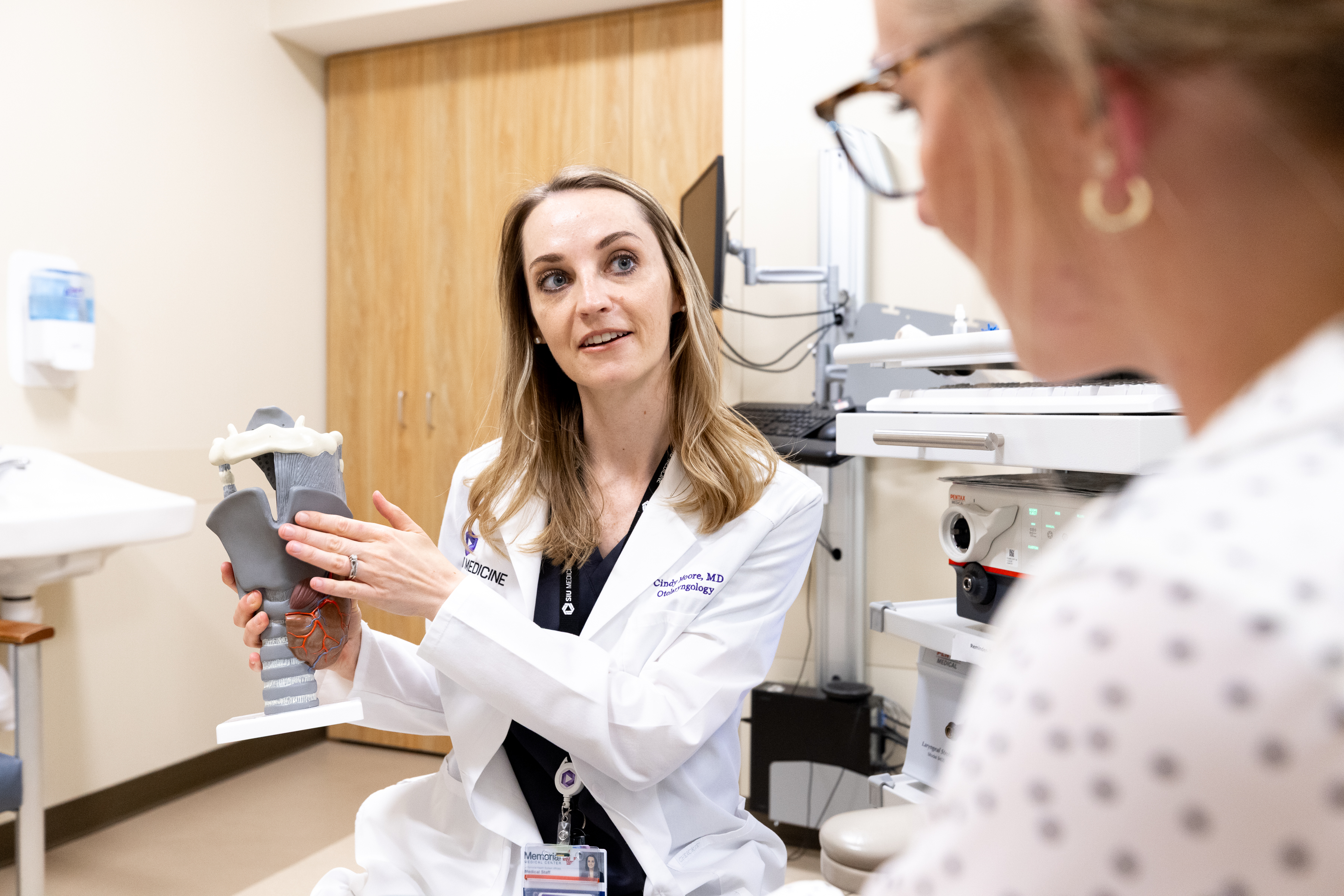 Laryngologist Dr. Cindy Moore educating patient