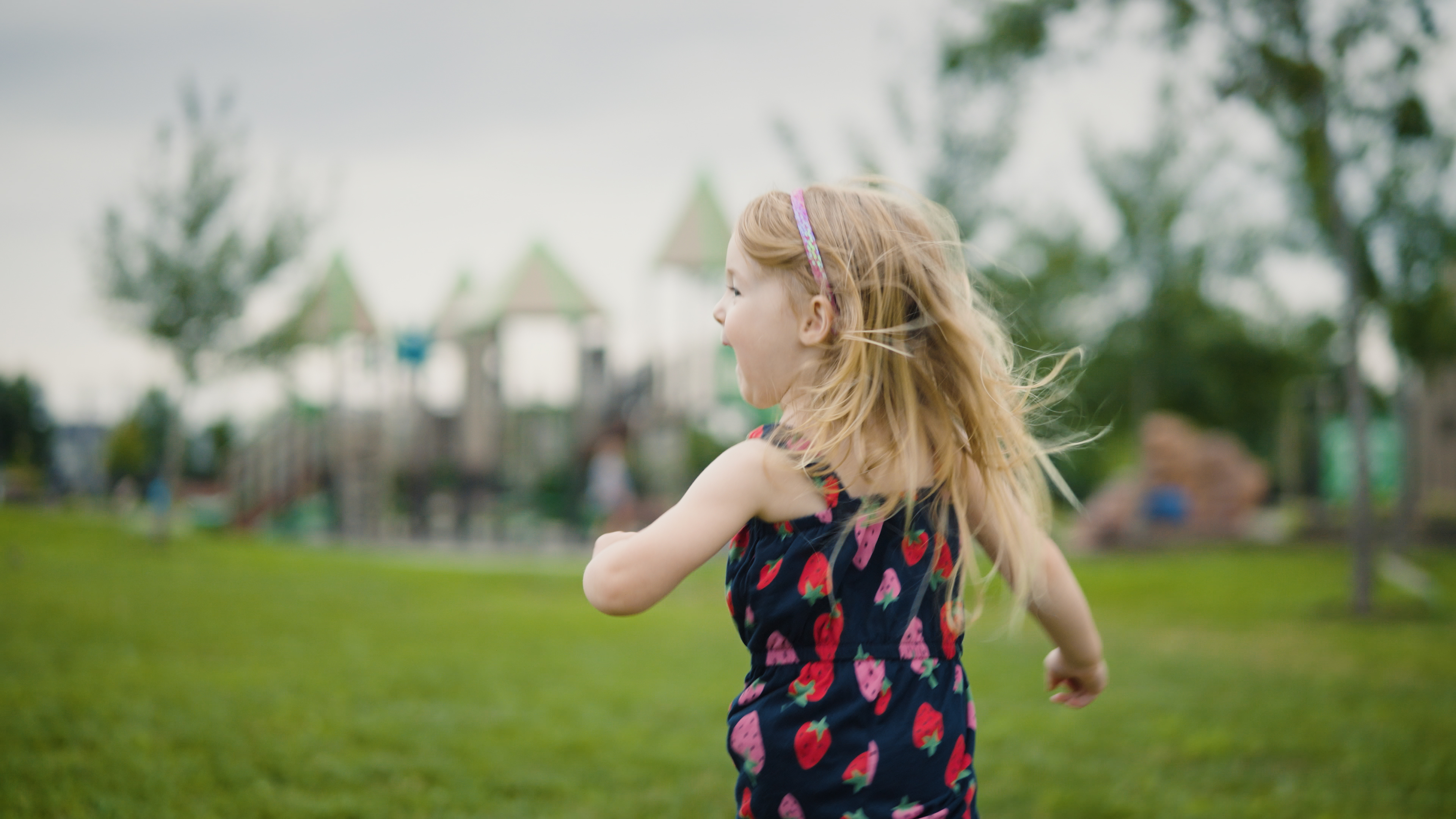 Annie Klemm joyfully runs towards the playground