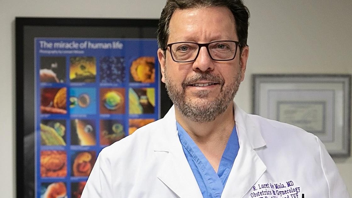 Dr. Loret de Mola Smiling in the IVF Office