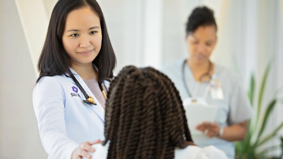Doctor comforts female patient photo