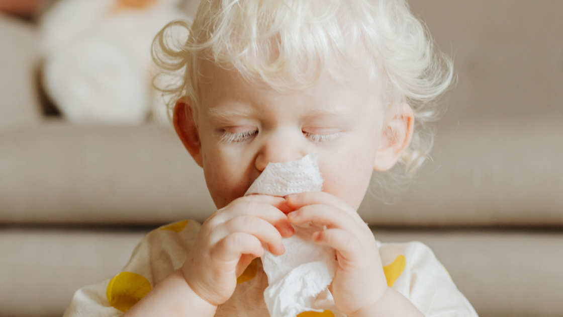 child nose blowing