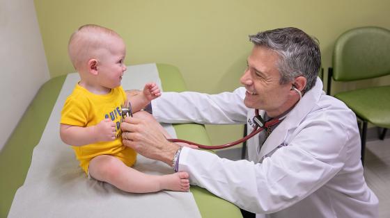 Doctor examining an infant