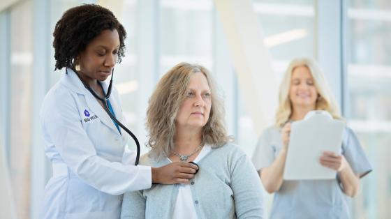 Doctor listens to patients heart photo