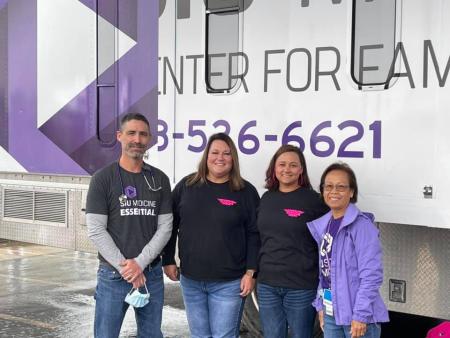 Faculty and staff stand in front of the SIU Medicine Care-a-van