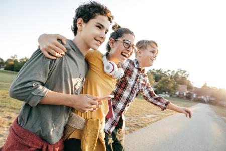Three children standing happily